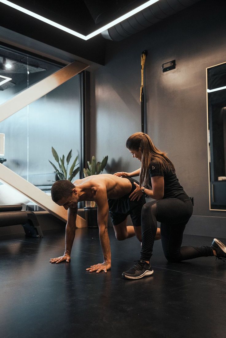 Trainer guiding an athlete through a stretch